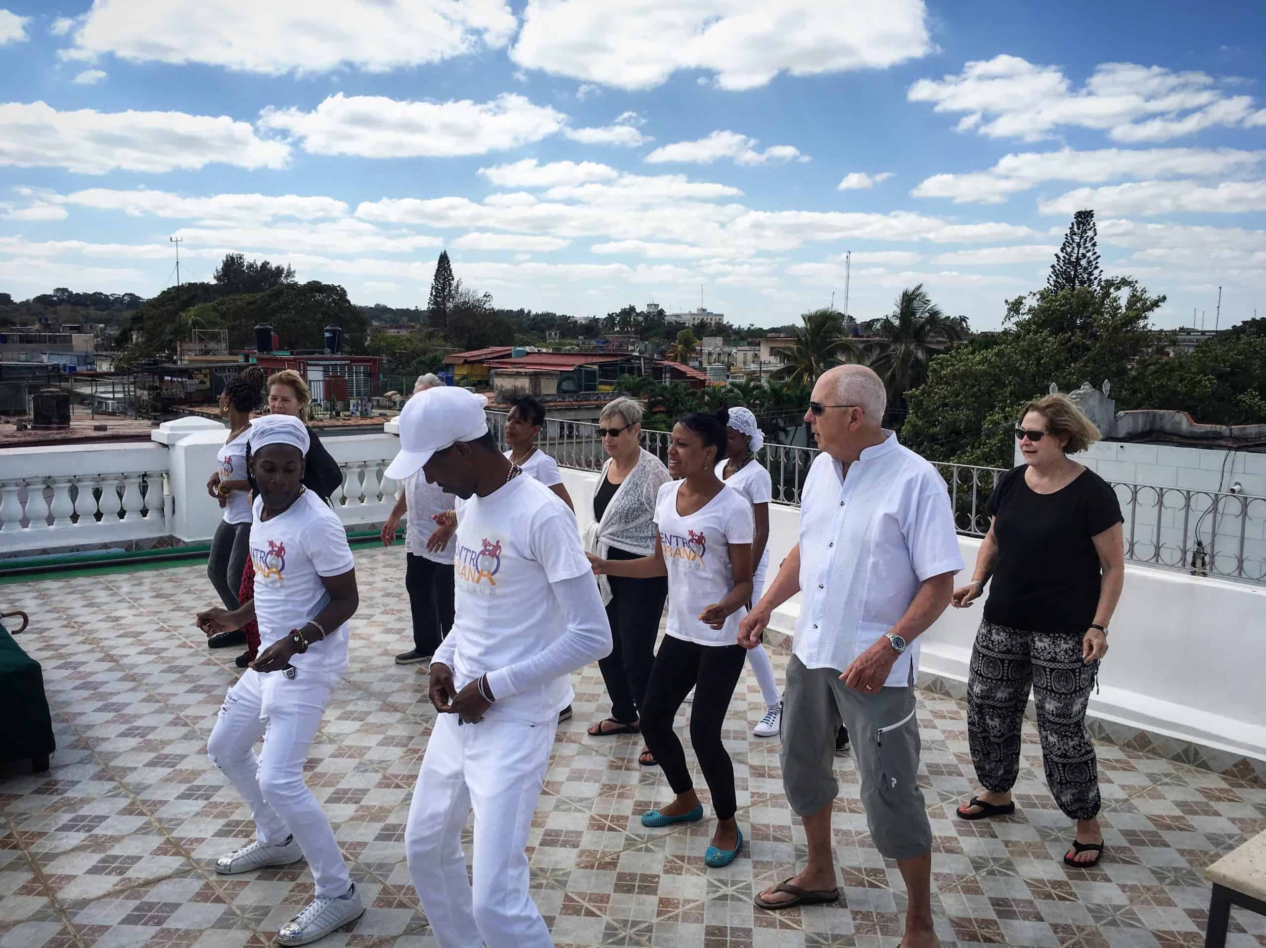 Participants practicing Cuban dance together on a Havana rooftop