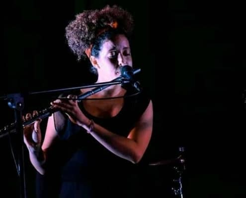 Rosi playing flute in Cuba