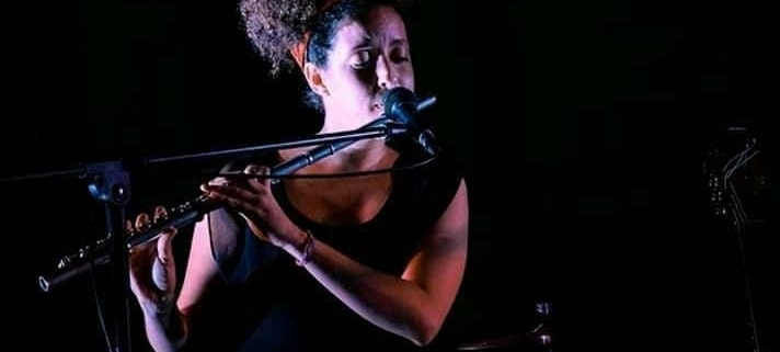 Rosi playing flute in Cuba