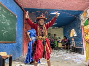 Folkloric dancer in a red costume performing with drummers in Cuba.